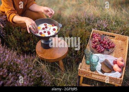 Woman travel making breakfast in the mountains Stock Photo