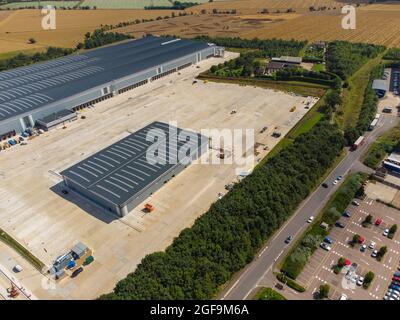 Aerial view of the Tritax Symmetry development at Symmetry Park, Biggleswade for the new portal framed regional distribution centre of the Co-op food group. This steel-framed building covers 661,000 sq ft, 357 metres long, 144 metres wide, there are is also a De-Kit building, for recycling packaging and a vehicle maintenance unit. Stock Photo