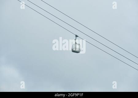 A low angle shot on a cable car against a cloudy sky background Stock Photo