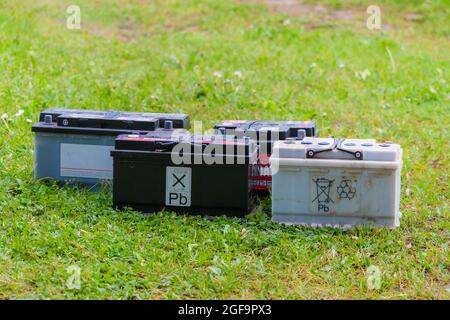 Pb lead car batteries on a grass in the nature on green grass Stock Photo