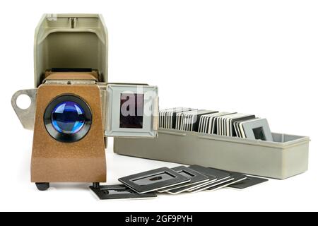 Old slide projector and set of slides isolated on white background. Retro equipment. Free space for text. Stock Photo