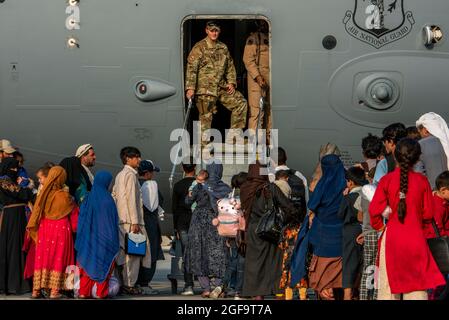 Al Udeied Air Base, Qatar. 22nd Aug, 2021. U.S. airmen, with the 379th Air Expeditionary Wing, prepare to board Afghan refugees on a C-17 Globemaster III aircraft for another transit camp in support of Operation Allies Refuge August 22, 2021 at Al Udeid Air Base, Qatar. Credit: Planetpix/Alamy Live News Stock Photo