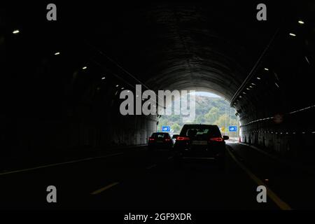 Malaga, Spain - August 24, 2021: Driver point of view personal perspective point of view in front of the cars driving through the tunnel. AP7 motorway