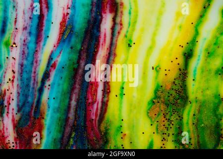 Multicolored colorful background of bright colors covered with gold sparkles. Stock Photo