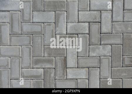 Gray paving slabs pavement background. Grey brick paving stones on city sidewalk. Top view Stock Photo