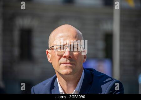 Profile of a young man wearing glasses, looking at the camera Stock Photo