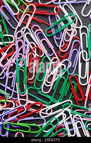Colored paper clips textured background, full screen Stock Photo