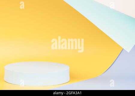 Abstract geometric background with empty round shape podium platform. light blue, yellow, green colors. Front view Stock Photo