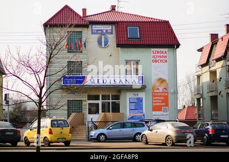 POZNAN, POLAND - Feb 23, 2015: Many parked cars in front of a Medisana medical office Stock Photo