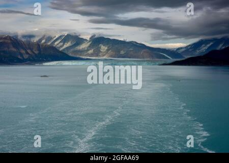 An Illustration of the wake of a cruise ship sailing away from Hubbard Glacier with a view of the glacier and mountains. Stock Photo