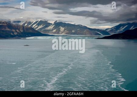 An Illustration of the wake of a cruise ship sailing away from Hubbard Glacier with a view of the glacier and mountains. Stock Photo