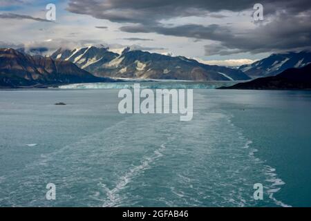 An illustration of the wake of a cruise ship sailing away from Hubbard Glacier with a view of the glacier and mountains. Stock Photo