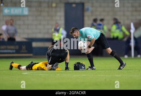 London, UK. 24th Aug, 2021. Referee Neil Hair checks on Adam May of Cambridge United during the Carabao Cup match between Millwall and Cambridge United at The Den, London, England on 24 August 2021. Photo by Alan Stanford/PRiME Media Images. Credit: PRiME Media Images/Alamy Live News Stock Photo