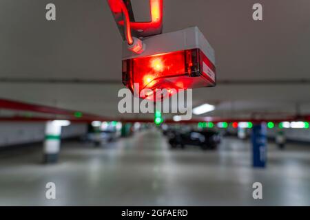 Underground car parks, car parks, red or green lights on the ceiling show drivers whether a parking space is free or occupied, and thus also measure t Stock Photo