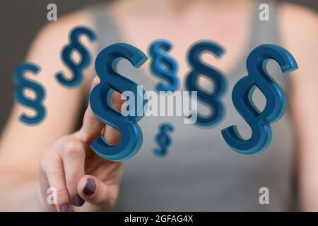 Lawyer's hand selecting from a 3D render of floating law and justice paragraph symbols Stock Photo