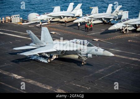 Arabian Sea, United States. 24th Aug, 2021. A U.S. Navy F/A-18E Super Hornet fighter jet, attached to the Diamondbacks of Strike Fighter Squadron 102, lands on the flight deck of aircraft carrier USS Ronald Reagan August 24, 2021 in the Arabian Sea. Credit: Planetpix/Alamy Live News Stock Photo