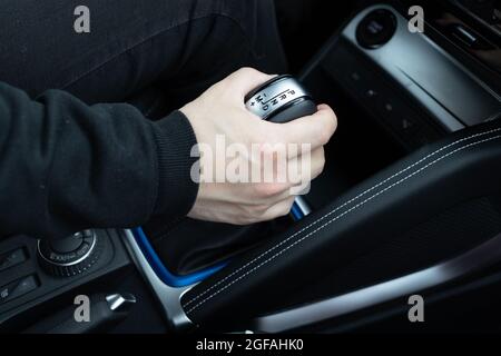 male hand shifts gears on the automatic transmission lever Stock Photo