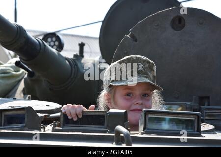 Marinka, Ukraine. 24th Aug, 2021. A young girl seen in the infantry combat vehicle during the Independence Day.August 24th, Ukraine celebrates the 30th anniversary of its Independence in honor of the adoption by the Verkhovna Rada of the Ukrainian SSR in 1991 of the Act of Independence of Ukraine - a political and legal document that certified the new status of the Ukrainian State. Credit: SOPA Images Limited/Alamy Live News Stock Photo