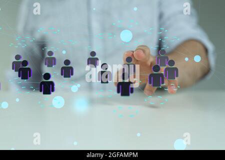 Male's hand pointing to an illustration ofNetwork connections team working and interacting Stock Photo