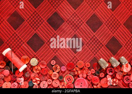 Red buttons, thimble, thread and needle for sewing. Seamstress Set Stock Photo