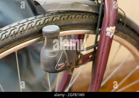 POZNAN, POLAND - Oct 11, 2017: A closeup shot of a dynamo on a bicycle tire and wheel Stock Photo