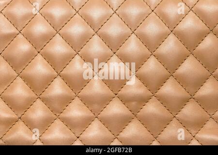 Golden colour shiny leather material pattern texture background Stock Photo