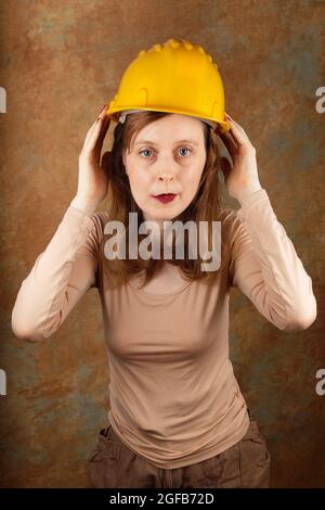 Young woman working in construction industry wearing protective helmet Stock Photo