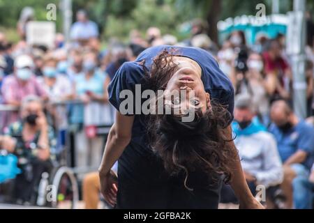 Barcelona, Spain. 24th Aug, 2021. A woman performs at the Sants festival in Barcelona neighborhood. The mayor of Barcelona, Ada Colau, has opened the traditional festival of the Sants neighborhood in Barcelona together with the honorees of that year's festival, Marta Sorribes, director of the neighborhood health center, and Joan Galimany, owner of a cake shop that is the oldest establishment in the neighborhood. Credit: SOPA Images Limited/Alamy Live News Stock Photo