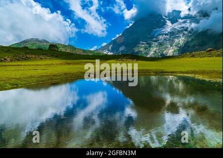 Reflection in water. On the trail of Gangabal Lake and Nundkol Lake at the base of Mount Harmukh. These twin lakes are on the Kashmir Great Lake Trek, Stock Photo