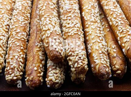 Sesame breadsticks (grissini al sesamo) close up isolated on wooden table Stock Photo