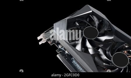 Video card with fan. Gaming graphics card for video games and cryptocurrency mining. Game video card isolated on black background. Electronic device, Stock Photo
