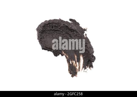 Wet black cosmetic clay smear isolated on white background. Abstract sample of black cosmetic clay. Facial beauty mask for skin detox. Stock Photo