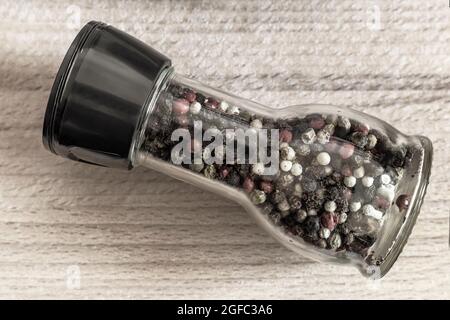 Various varieties of pepper in a glass bottle Stock Photo