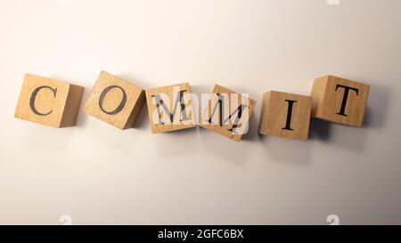 The word Commit was created from wooden cubes. Stock Photo