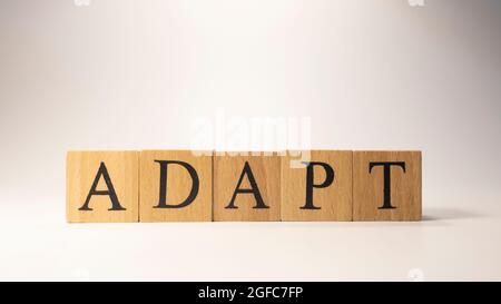 The word ADAPT was created from wooden cubes.Close-up. Stock Photo