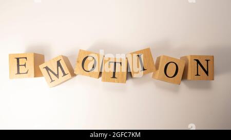 The word Emotion was created from wooden cubes. Psychology and feelings Stock Photo