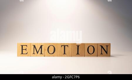 The word Emotion was created from wooden cubes. Psychology and feelings Stock Photo