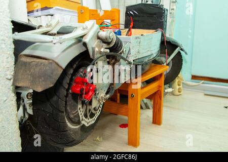 disassembled electric scooter pulled out battery Stock Photo