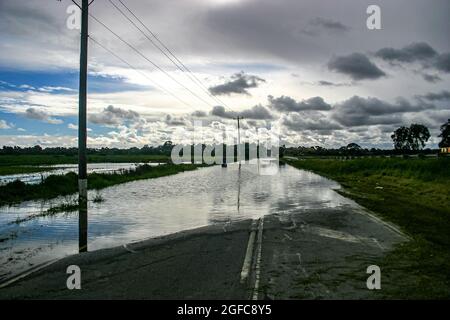 A cloudy sky reflecting in the flood waters across Heatherton Road highway in Dandenong Stock Photo