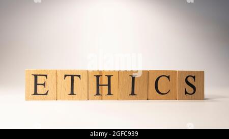 The word Ethics was created from wooden cubes. Rules and morals. close-up. Stock Photo