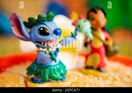 New York, USA - June 25, 2021: Close-up shot of Stitch figure in Foreground and in Focus and Lilo blurred out in background on a molded cake. Stock Photo