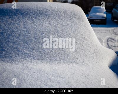 Fresh wite snow on a completely covered car windscreen in a morning. Winter season Stock Photo