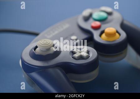 Photo of a gaming controller on blue background Stock Photo