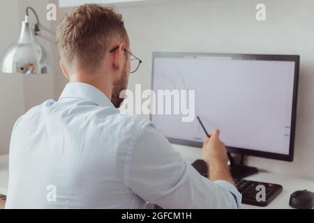 businessman looking on stock chart on screen Stock Photo