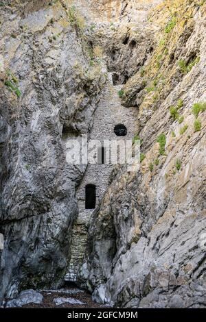 Culver Hole, a secret Smugglers cave built into the cliff, Port Eynon, Gower Peninsula, South Wales, the United Kingdom Stock Photo