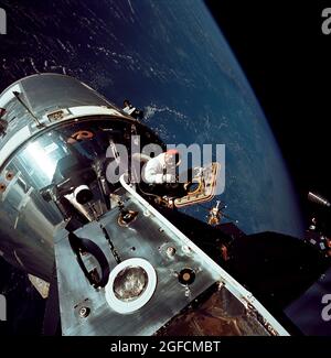 (6 March 1969) --- Excellent view of the docked Apollo 9 Command and Service Modules (CSM) and Lunar Module (LM), with Earth in the background, during astronaut David R. Scott's stand-up extravehicular activity (EVA), on the fourth day of the Apollo 9 Earth-orbital mission. Scott, command module pilot, is standing in the open hatch of the Command Module (CM) Stock Photo