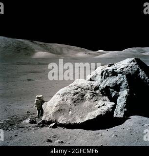 (13 Dec. 1972) --- Scientist-astronaut Harrison H. Schmitt is photographed standing next to a huge, split lunar boulder during the third Apollo 17 extravehicular activity (EVA) at the Taurus-Littrow landing site. Schmitt is the Apollo 17 lunar module pilot. Stock Photo