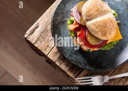 Beef burger with cheese and bacon on rustic wooden table Stock Photo