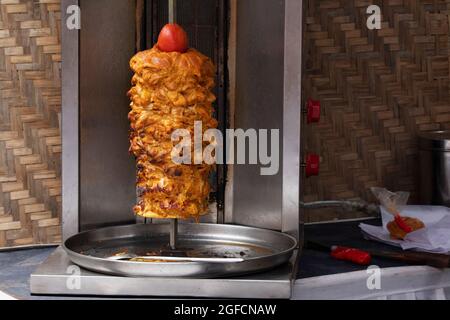 Shawarma an Arab dish with meat cut into thin slices stacked in a cone-like shape and roasted on a slowly-turning vertical rotisserie, Pune, Maharasht Stock Photo