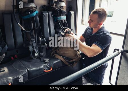 Fireman checking professional firefighting equipment Stock Photo
